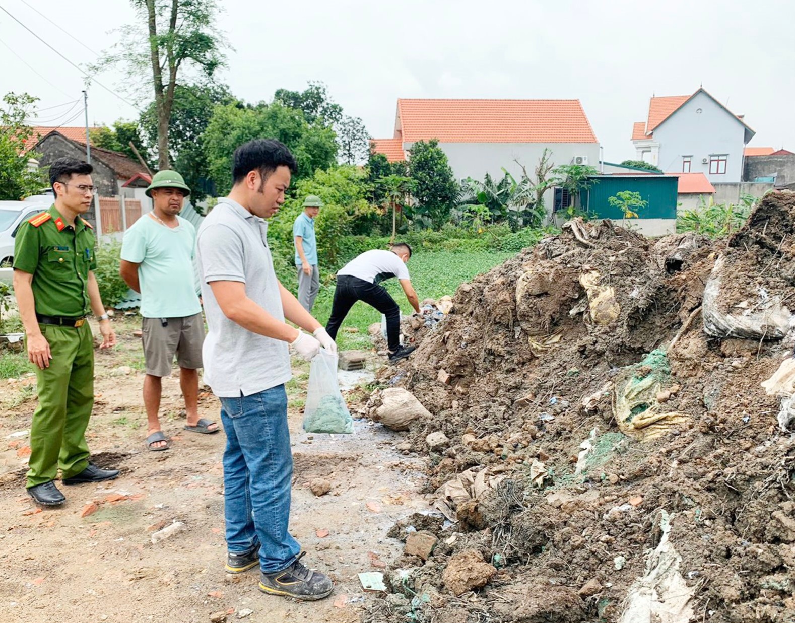 Khởi tố 3 đối tượng ch&ocirc;n hơn 400 tấn chất thải để san lấp ao- Ảnh 1.