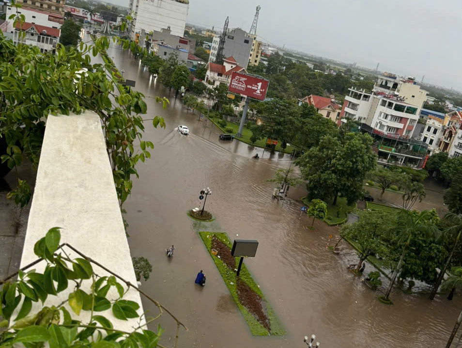 Nhiều khu vực TP Nam Định ngập s&acirc;u, cảnh s&aacute;t d&ugrave;ng xe c&ocirc;ng vụ đưa d&acirc;n qua đường- Ảnh 1.