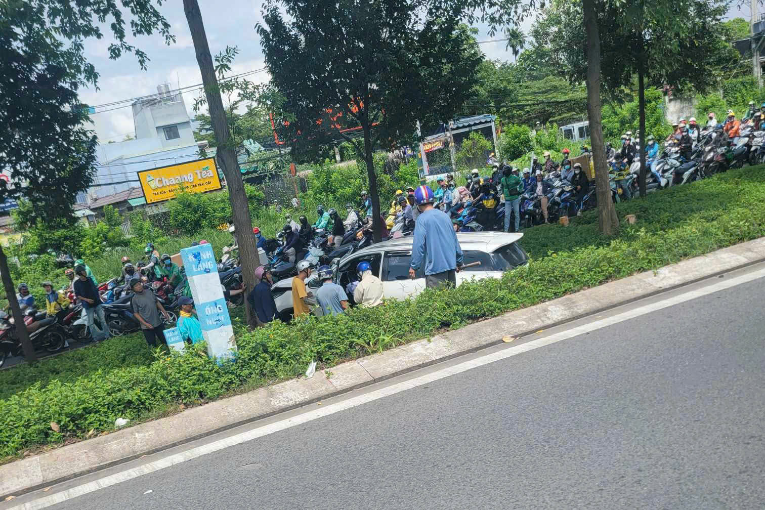 TP.HCM: Người d&acirc;n ph&aacute; cửa cứu t&agrave;i xế bất tỉnh trong &ocirc; t&ocirc; 7 chỗ t&ocirc;ng tr&uacute;ng gốc c&acirc;y- Ảnh 1.