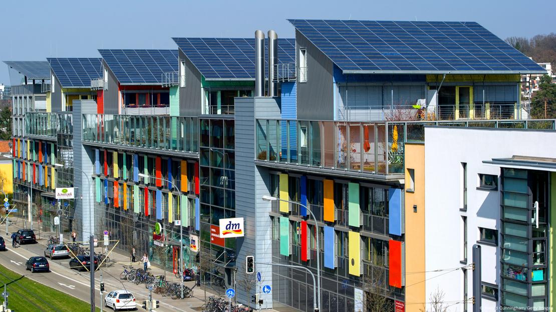 A row of multi-story buildings with solar panels  AI-generated content may be incorrect.