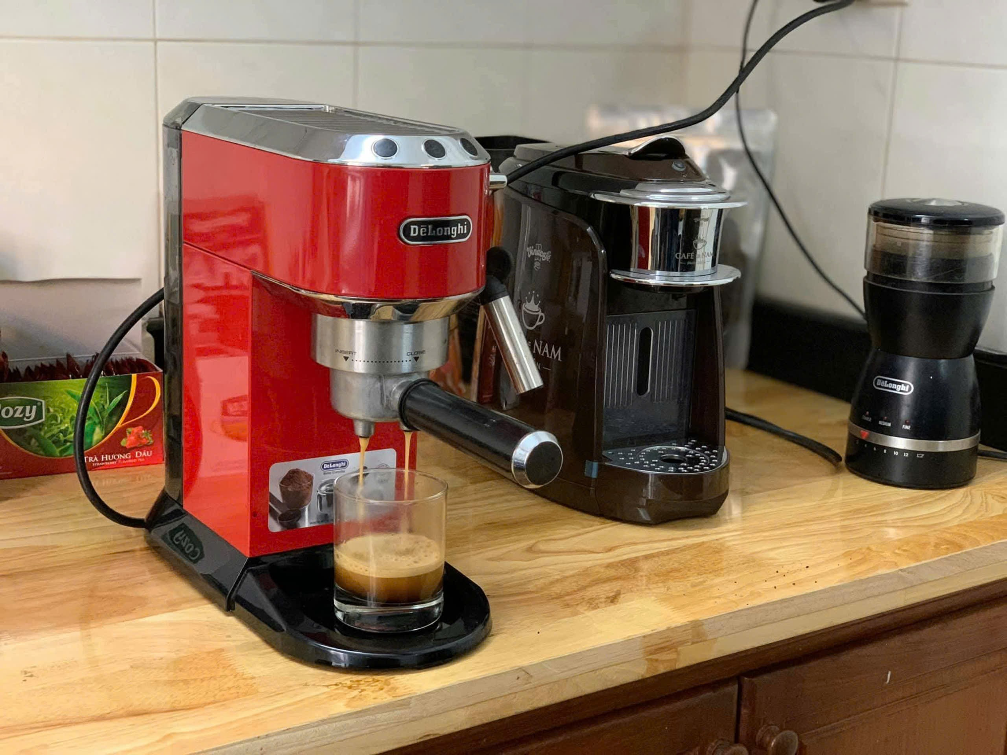 A red and black machine on a counter  Description automatically generated