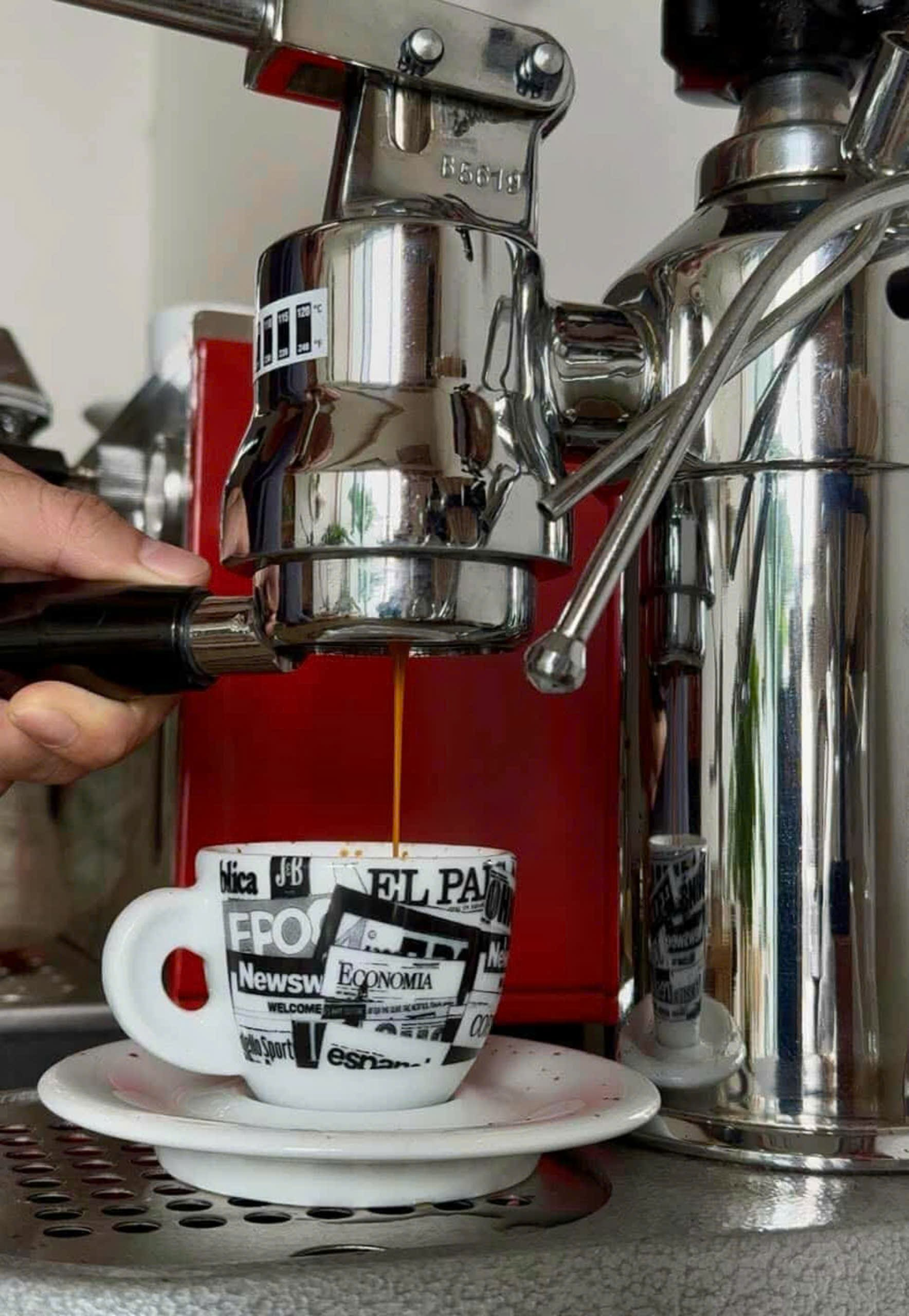 A close-up of a coffee machine  Description automatically generated