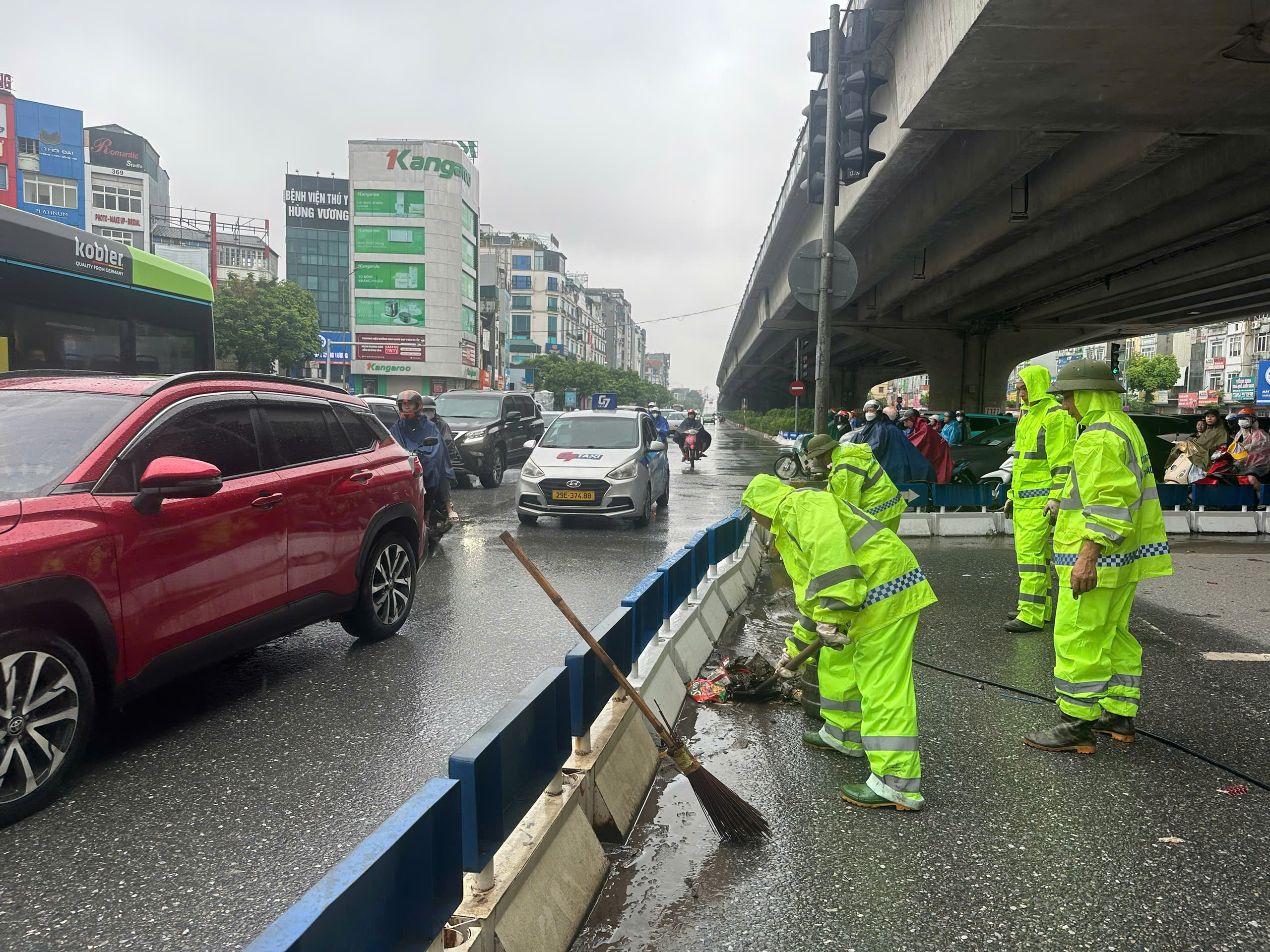 Ch&ugrave;m ảnh: C&ocirc;ng nh&acirc;n tất bật "đội mưa" chỉnh trang đ&ocirc; thị, giao th&ocirc;ng trước kỳ nghỉ lễ 2/9 - Ảnh 4.