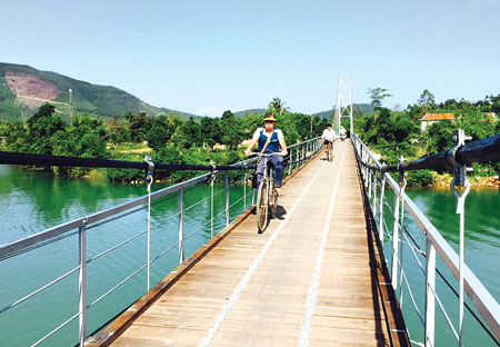 Nhờ c&acirc;y cầu treo mới được sửa chữa, h&agrave;ng trăm học sinh ba cấp ở x&atilde; Li&ecirc;n Trạch tho&aacute;t cảnh xếp h&agrave;ng chờ đ&ograve; ngang tới lớp