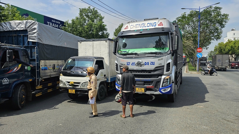 L&aacute;ch qua xe tải để sang đường, hai mẹ con đi xe m&aacute;y bị cuốn v&agrave;o gầm- Ảnh 1.