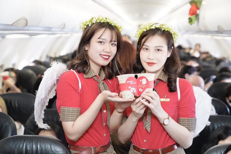 A couple of women in uniform holding food  Description automatically generated