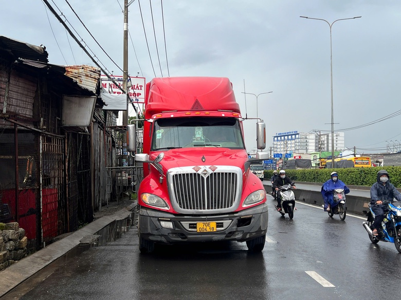 Vượt đ&egrave;n đỏ, người phụ nữ đi xe đạp điện trọng thương sau va chạm với xe container- Ảnh 1.