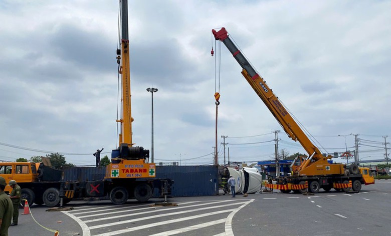 Hai cần cẩu được điều đến để di dời xe container bị lật.