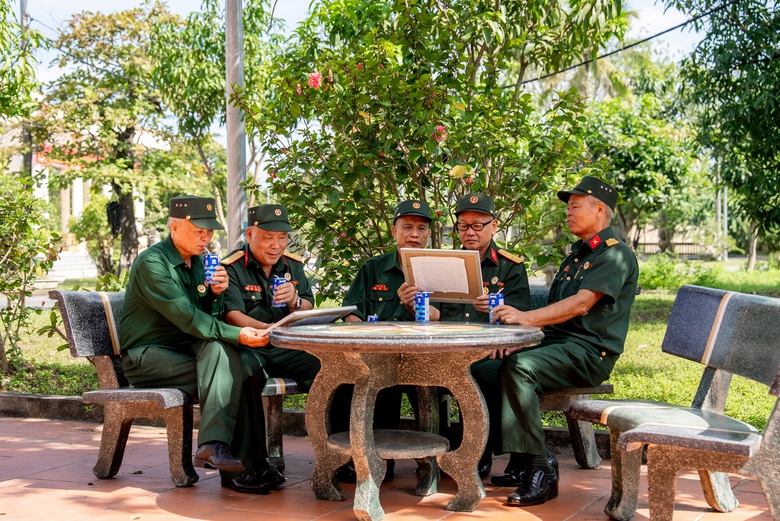 C&aacute;c b&aacute;c cựu chiến binh chăm ch&uacute; đọc những d&ograve;ng chữ nhỏ, được c&aacute;c em gửi k&egrave;m trong mỗi bức tranh (Ảnh: Duy Cường).