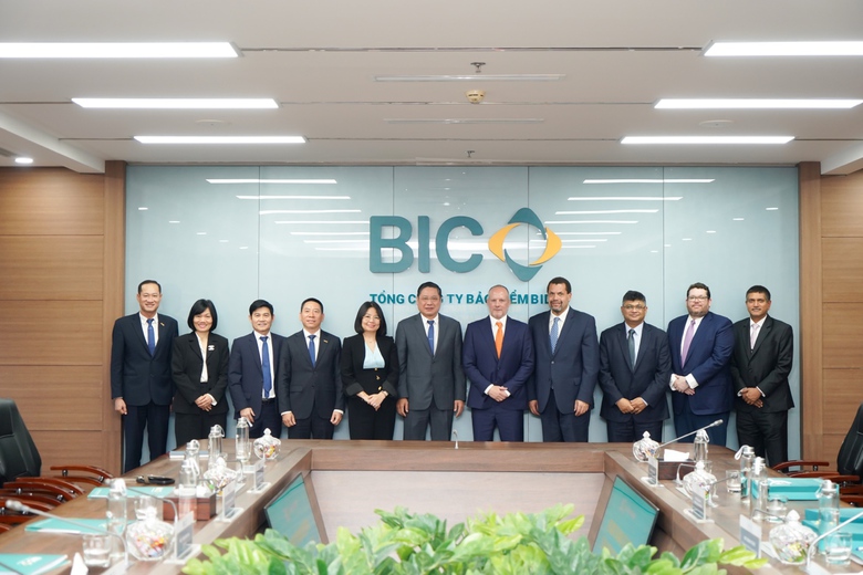 A group of people in suits standing in front of a wall  AI-generated content may be incorrect.