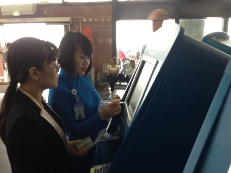 Kh&aacute;ch chưa biết sử dụng m&aacute;y l&agrave;m thủ tục tự động được nh&acirc;n vi&ecirc;n hướng dẫn tận t&igrave;nh