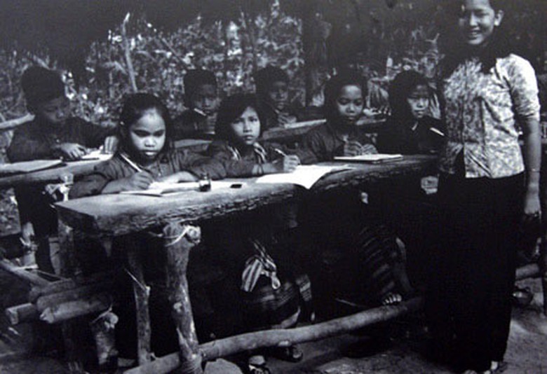 D&ugrave; điều kiện vật chất thiếu thốn, b&agrave;n ghế được gh&eacute;p tạm bợ từ những c&acirc;y rừng nhưng c&ocirc; tr&ograve; đều rất vui vẻ v&agrave; cố gắng. Đ&acirc;y l&agrave; một lớp học dưới l&aacute;n thời chiến