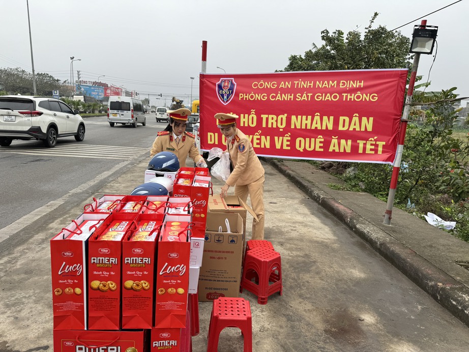 Cảnh s&aacute;t giao th&ocirc;ng Nam Định tặng qu&agrave; nh&acirc;n d&acirc;n tr&ecirc;n đường về qu&ecirc; ăn Tết- Ảnh 1.