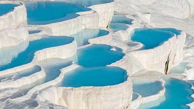 Pamukkale, Thổ Nhĩ Kỳ: Đ&acirc;y l&agrave; một di sản thế giới tuyệt đẹp của UNESCO ở ph&iacute;a t&acirc;y nam Thổ Nhĩ Kỳ. Th&aacute;c nước từ suối tự nhi&ecirc;n chảy xuống ruộng bậc thang m&agrave;u trắng v&agrave; tạo th&agrave;nh những hồ nước n&oacute;ng tuyệt vời.&nbsp;
