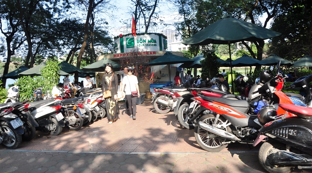 Xe đỗ tr&ecirc;n vỉa h&egrave; dẫn v&agrave;o một qu&aacute;n giải kh&aacute;t b&ecirc;n Hồ Ho&agrave;n Kiếm.