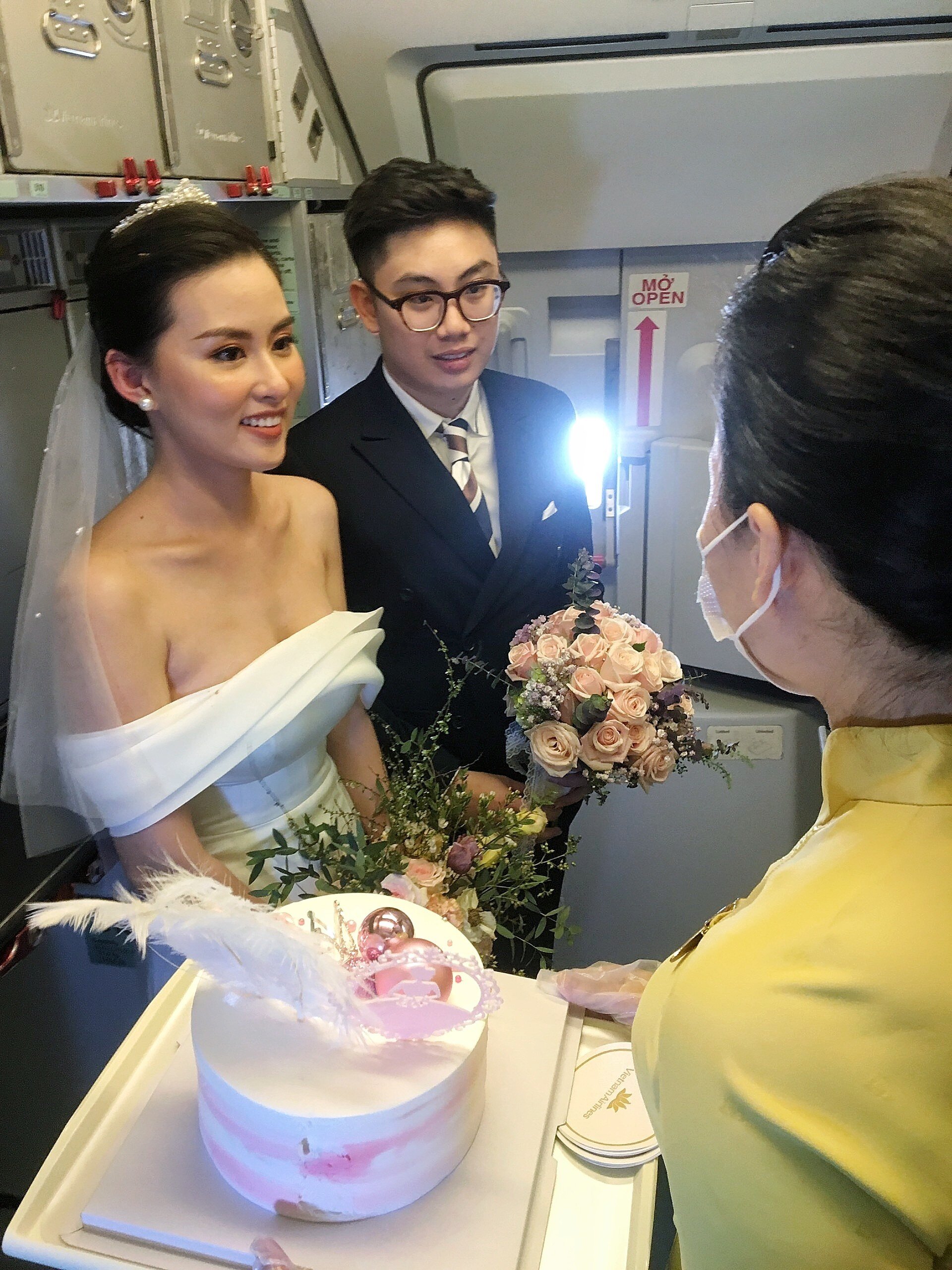 Tiếp vi&ecirc;n trưởng chuyến bay thay mặt phi h&agrave;nh đo&agrave;n v&agrave; h&agrave;nh kh&aacute;ch tặng qu&agrave; kỷ niệm cho cặp đ&ocirc;i.