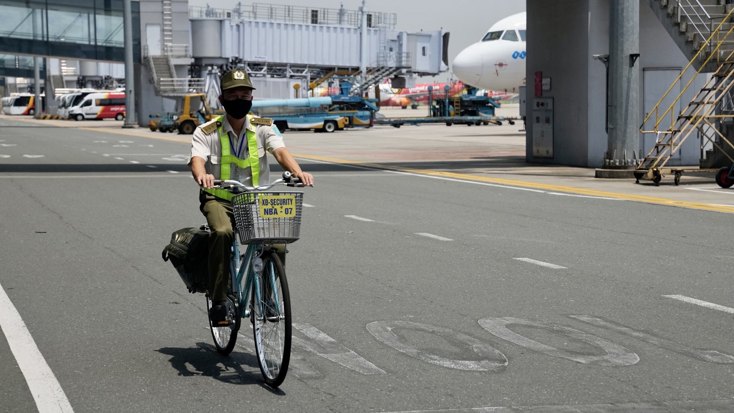 Một nh&acirc;n vi&ecirc;n an ninh kiểm so&aacute;t s&acirc;n đỗ t&agrave;u bay đang đi tuần tra trong khu bay