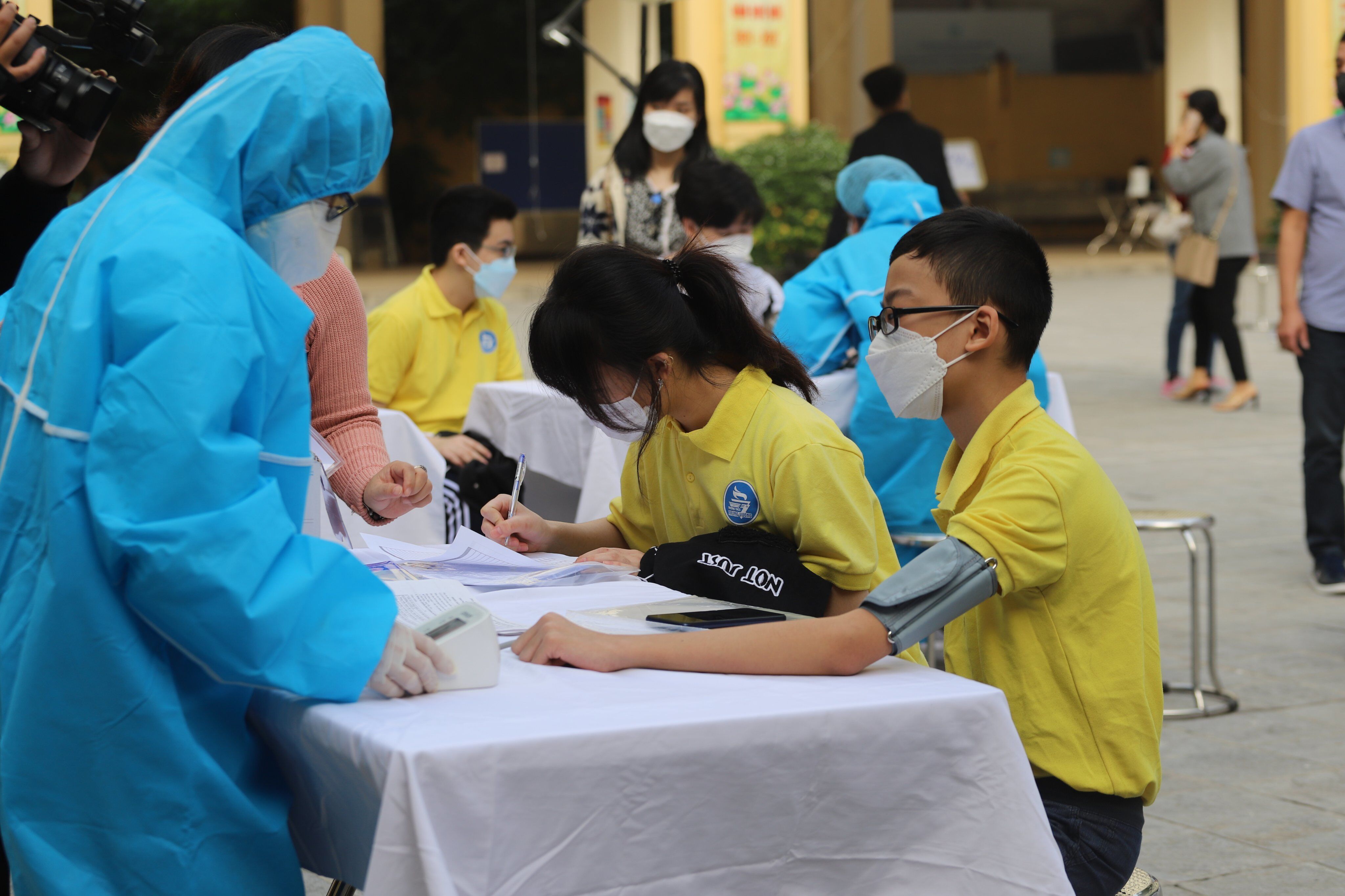 Thủ tục kh&aacute;m sức khỏe trước khi ti&ecirc;m được c&aacute;c nh&acirc;n vi&ecirc;n y tế thực hiện cẩn trọng với c&aacute;c em học sinh.