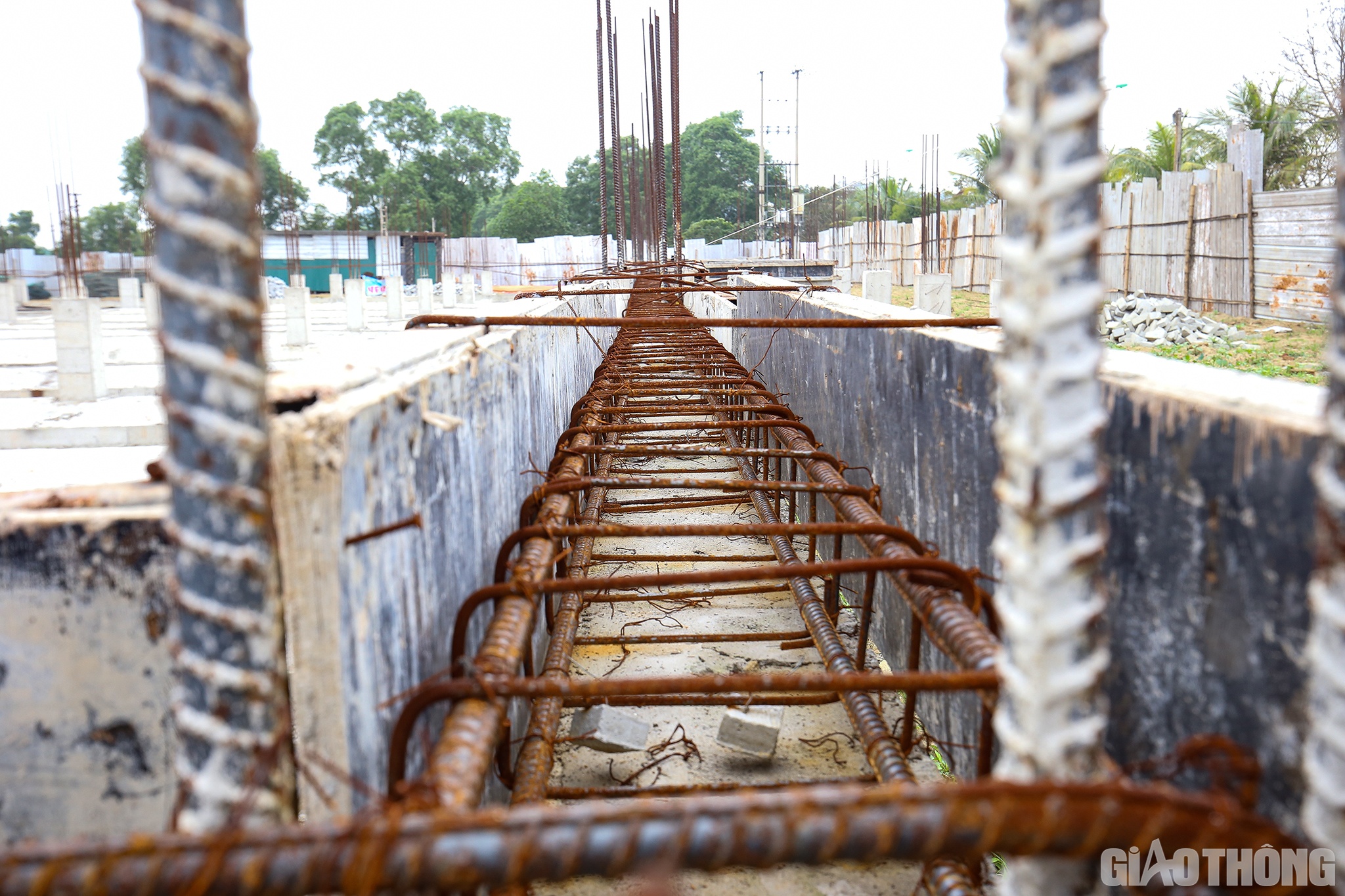 Do để ngo&agrave;i trời l&acirc;u ng&agrave;y kh&ocirc;ng được che đậy n&ecirc;n hầu hết phần sắt l&ograve;i ra ngo&agrave;i của m&oacute;ng c&ocirc;ng tr&igrave;nh đ&atilde; bị gỉ s&eacute;t, nhiều tấm v&aacute;n cốt pha để l&oacute;t đổ b&ecirc; t&ocirc;ng nằm lăn l&oacute;c ngo&agrave;i trời, một số &iacute;t kh&aacute;c được che đậy bằng những tấm lưới.