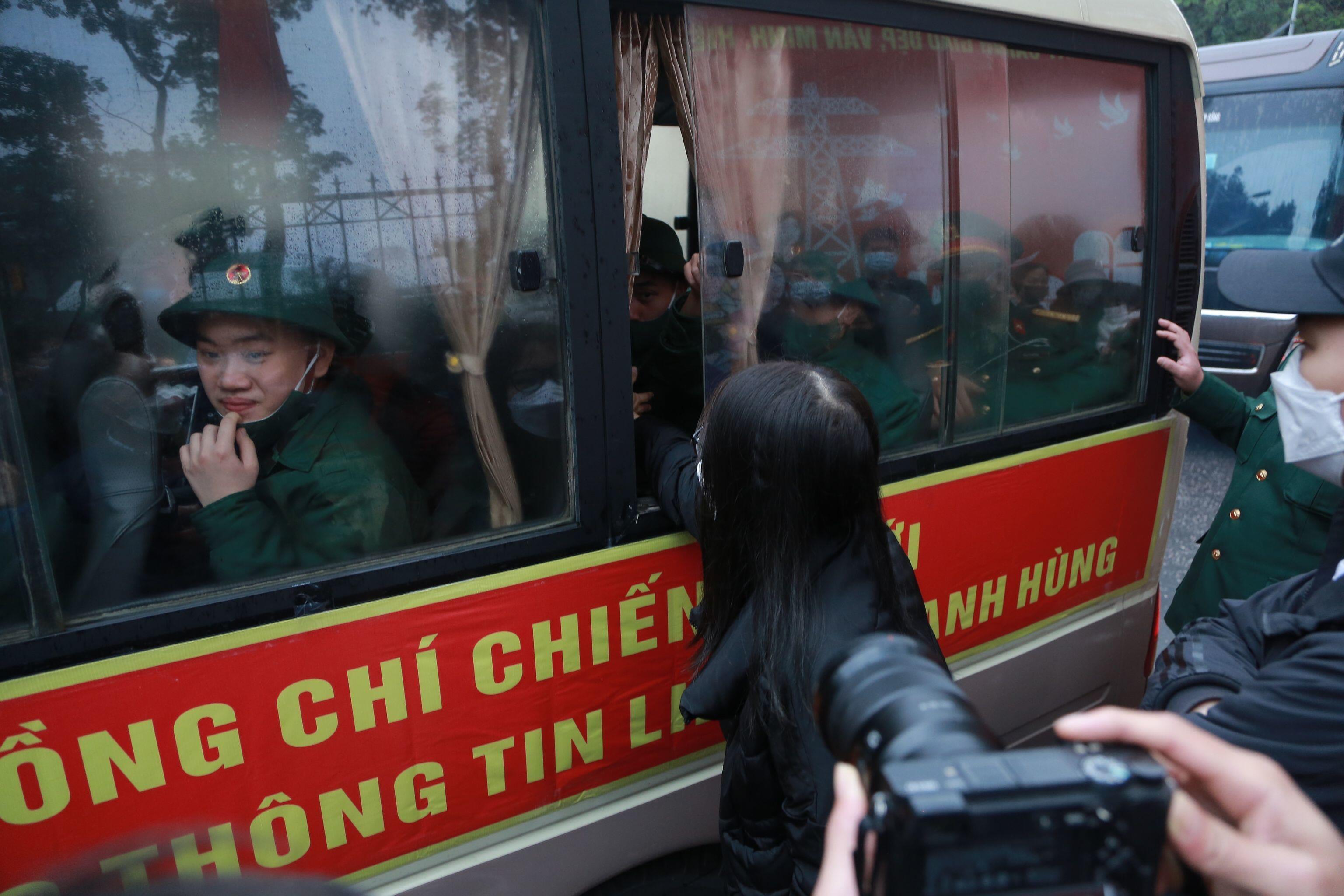 Một số người th&acirc;n c&ograve;n đưa tay v&agrave;o bắt tay c&aacute;c chiến sĩ lần cuối trước những người l&iacute;nh trẻ nhập ngũ.