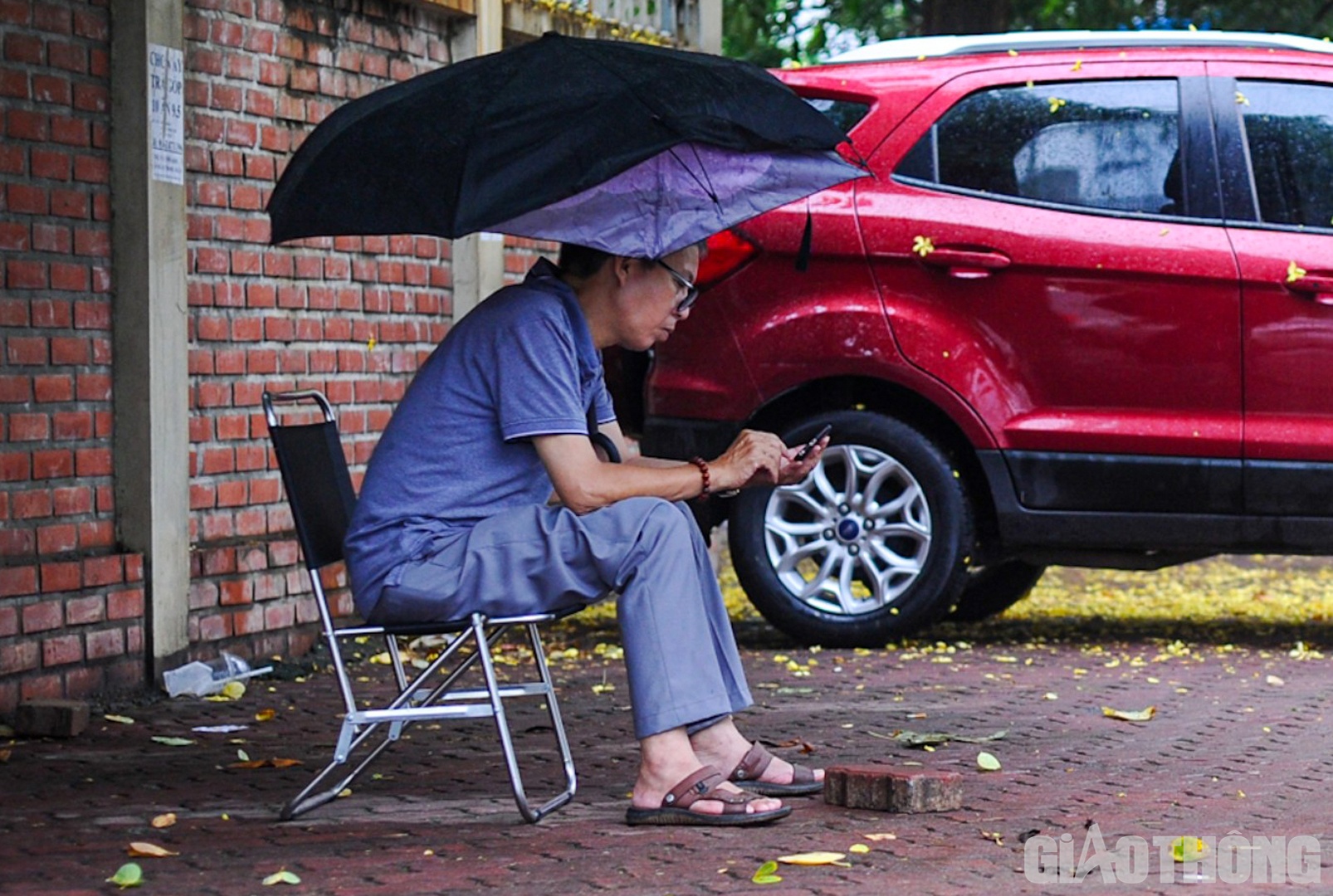 T&igrave;m một chỗ tr&uacute; mưa dưới t&aacute;n c&acirc;y, anh L&ecirc; Anh Tuấn (quận T&acirc;y Hồ) cho hay: "Giờ về cũng sốt ruột n&ecirc;n t&ocirc;i quyết định đợi ở b&ecirc;n ngo&agrave;i cổng trường thi cũng như để tiếp th&ecirc;m tinh thần cho con l&agrave;m b&agrave;i được tốt hơn".