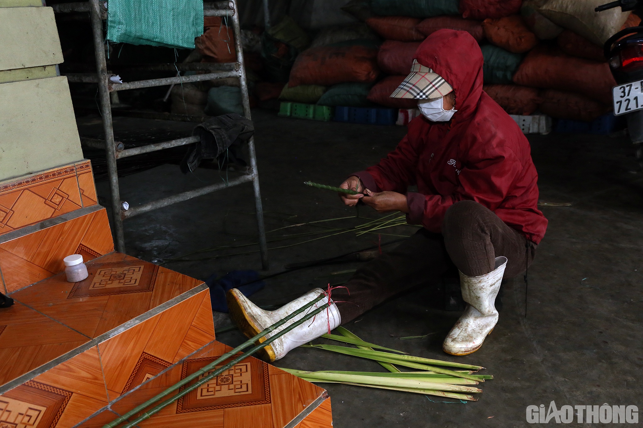 Ngo&agrave;i ra, tuỳ v&agrave;o từng loại c&aacute;, người thợ sẽ xếp đều l&ecirc;n vỉ nướng hay g&aacute;c tr&ecirc;n c&aacute;c thanh sắt đ&atilde; được quấn th&ecirc;m l&aacute; dừa nhằm cho sạch v&agrave; thơm. (Trong ảnh l&agrave; người thợ đang quấn l&aacute; dừa v&agrave;o thanh sắt để nướng c&aacute; cắt kh&uacute;c)