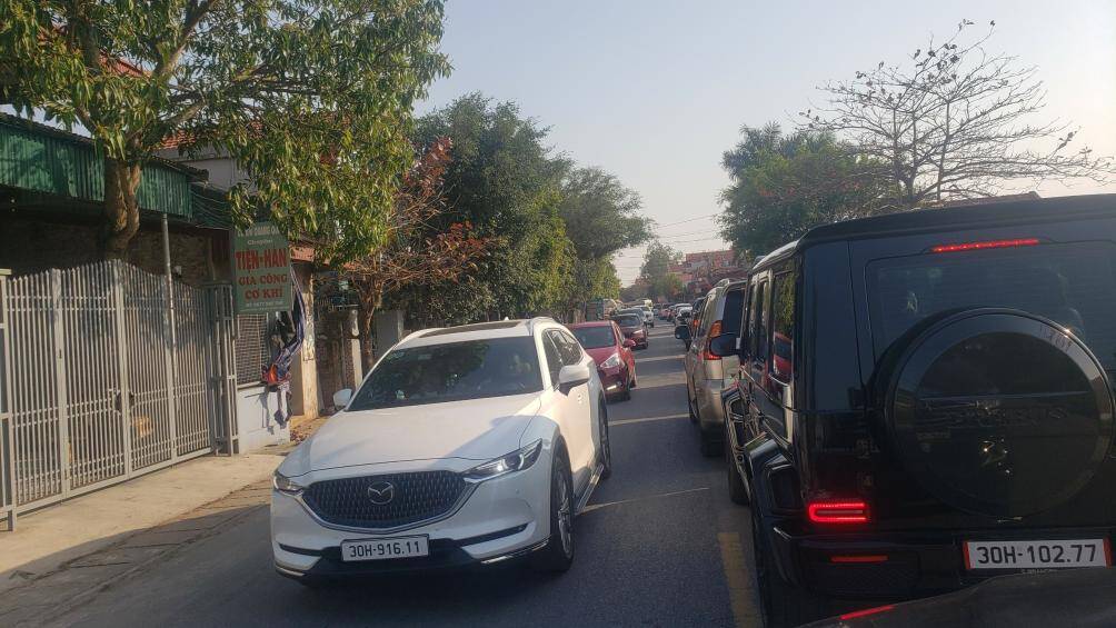 Tr&ecirc;n con đường dẫn v&agrave;o khu vực tổ chức chợ Viềng, xe &ocirc; t&ocirc; nối đu&ocirc;i nhau. Mặc d&ugrave; c&oacute; lực lượng chức năng điều tiết nhưng vẫn xảy ra t&igrave;nh trạng &ugrave;n ứ.