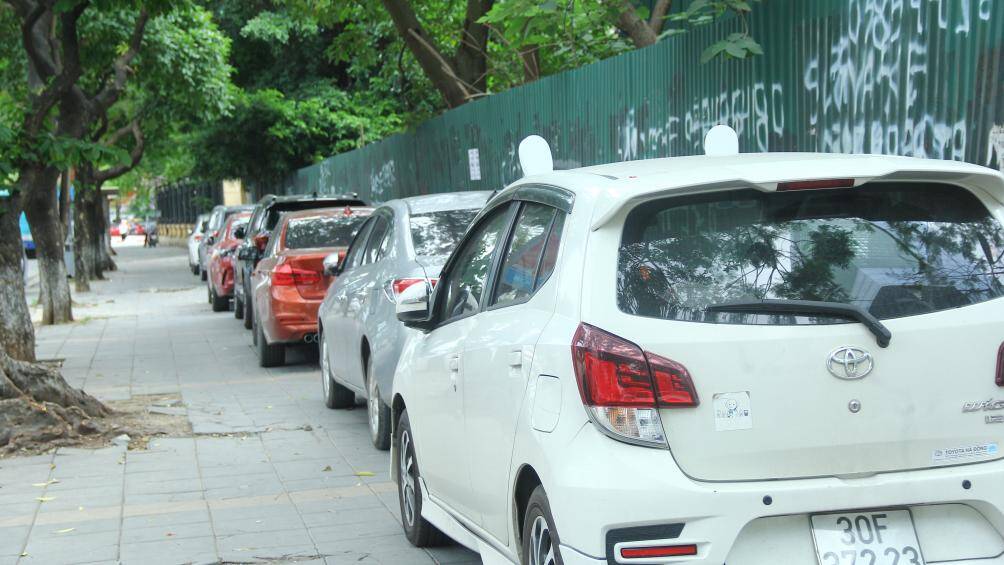 H&agrave;ng d&agrave;i xe &ocirc; t&ocirc; đỗ tr&ecirc;n vỉa h&egrave; đường Trần Duy Hưng. Đ&acirc;y cũng l&agrave; nguy&ecirc;n nh&acirc;n khiến tuổi thọ của gạch l&aacute;t vỉa h&egrave; bị suy giảm.