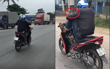 Nam thanh niên lái xe bằng chân, tay dùng điện thoại trên QL1